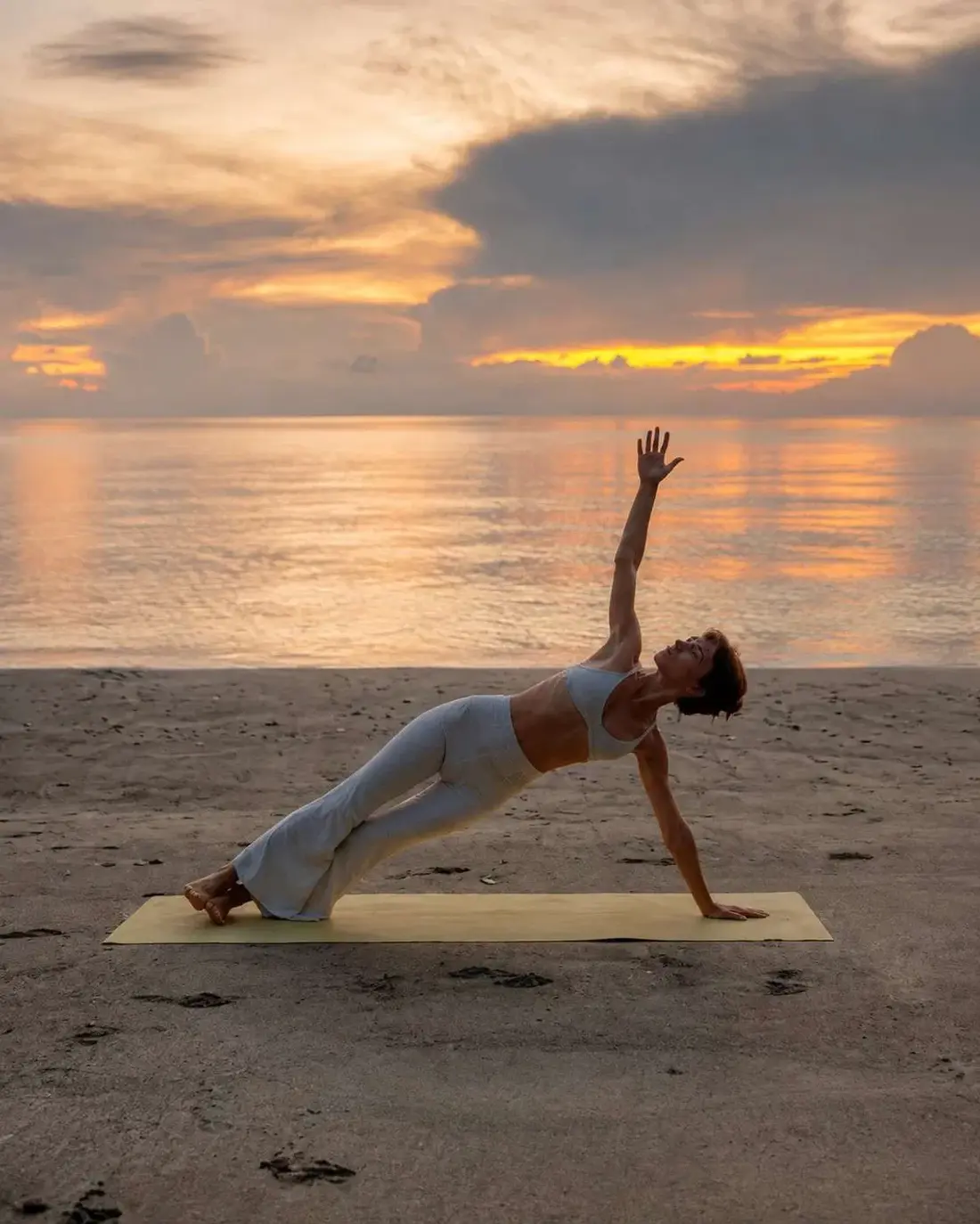 Yoga practice on the beach at sunset